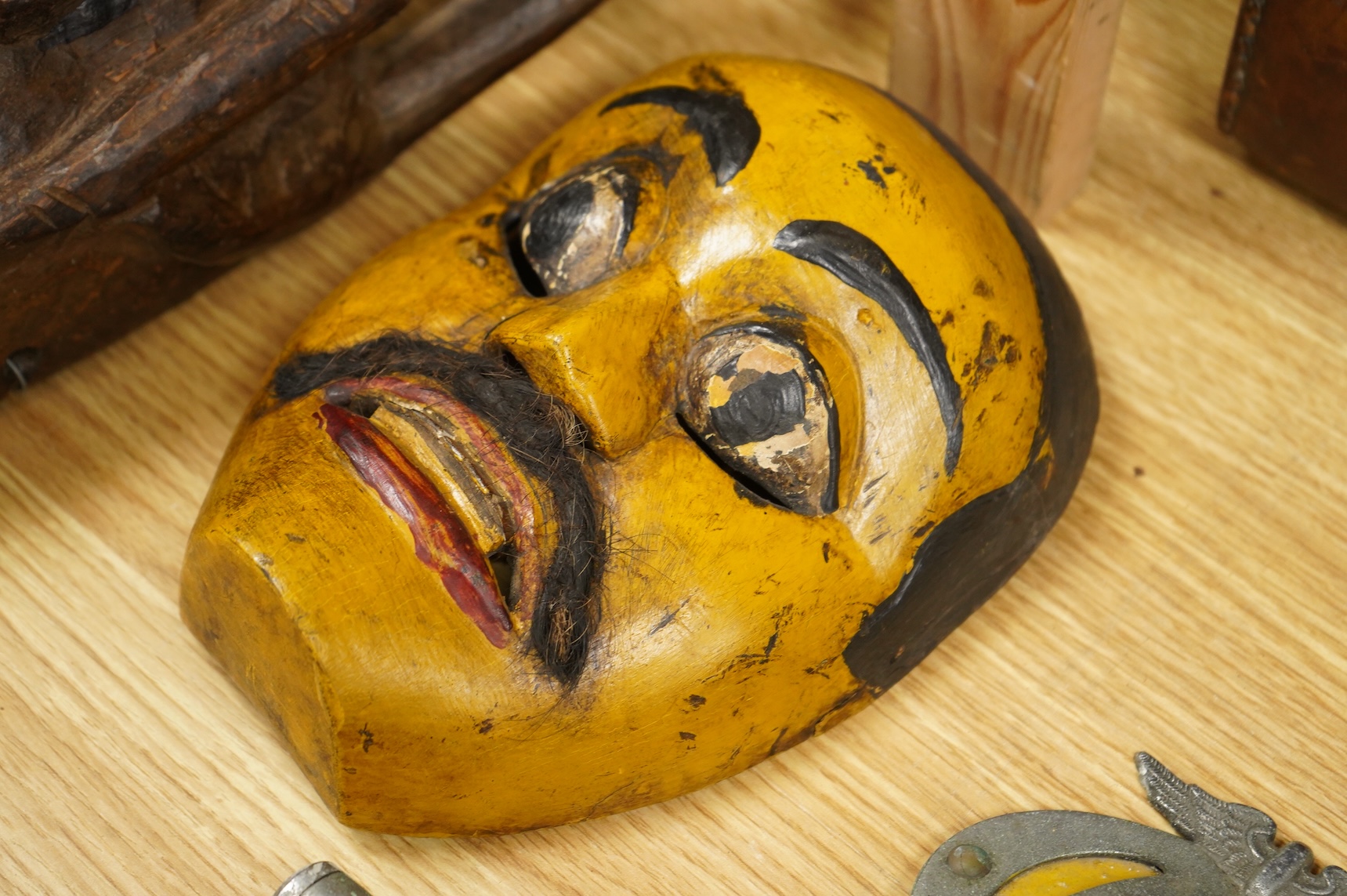 A collection of seven Nepalese, African and Indonesian masks to include a Magar example and one from the Dan Tribe, Liberia, largest 40cm